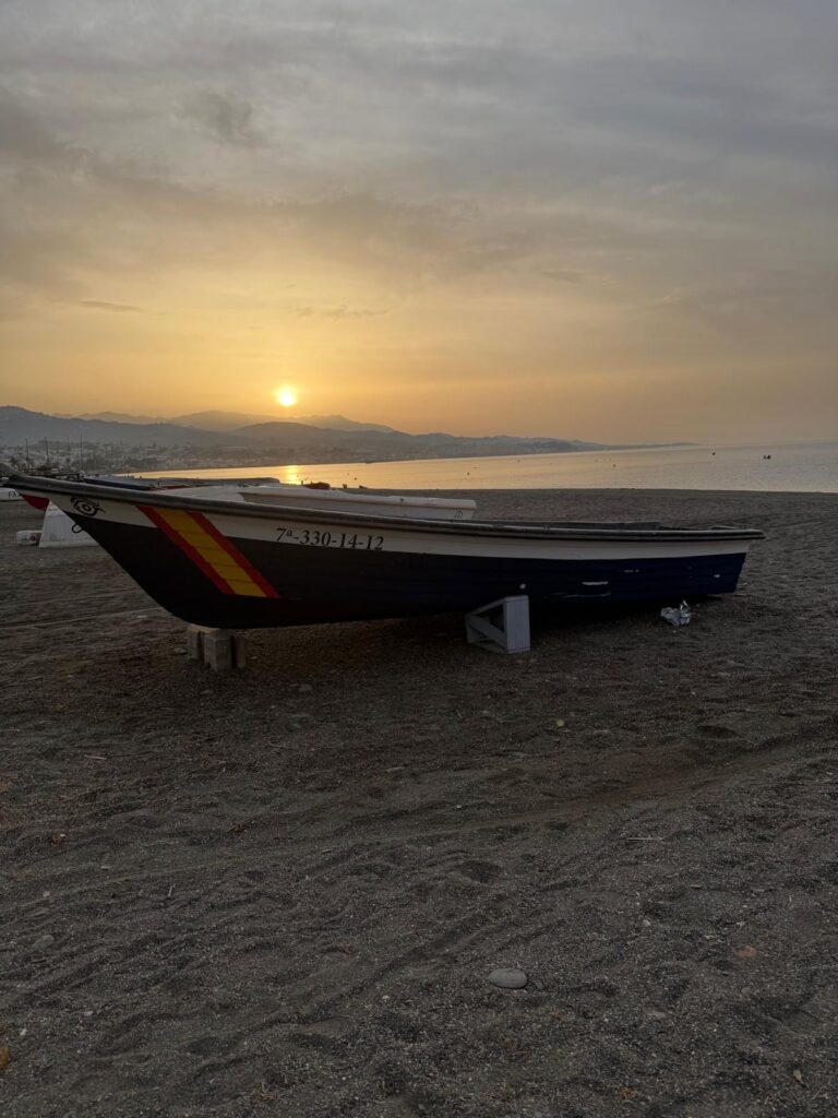 Barque de pêcheur sur la plage au lever du soleil